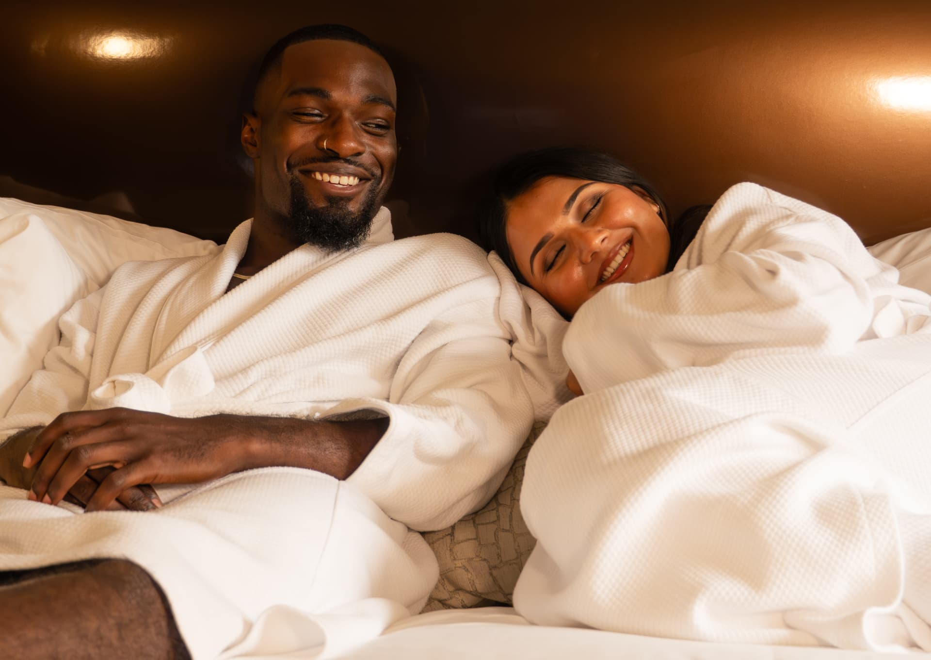 Guests relaxing in robes in an Omni Charlotte hotel suite